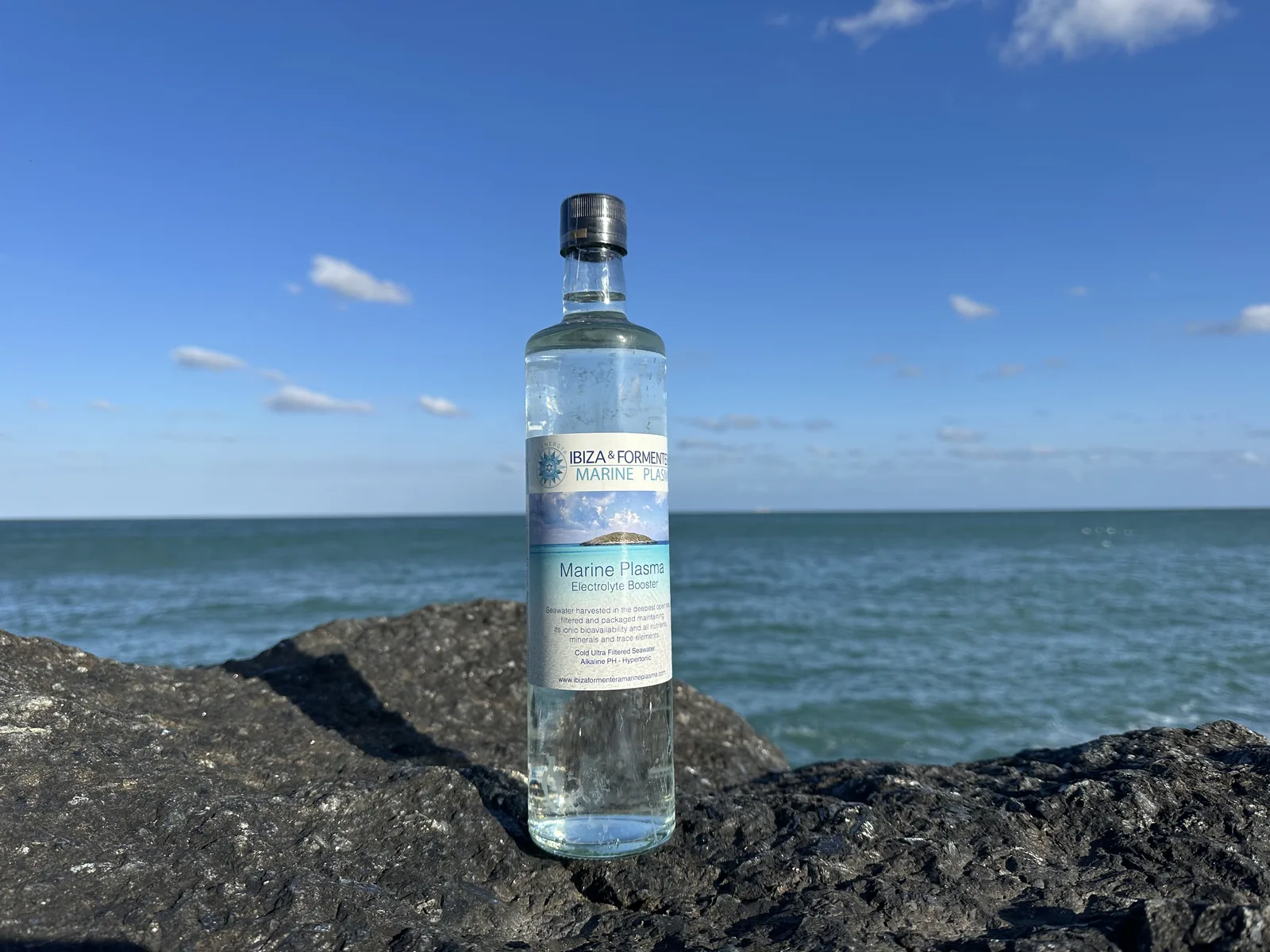 Ibiza & Formentera Marine Plasma bottle on rocks beside the sea