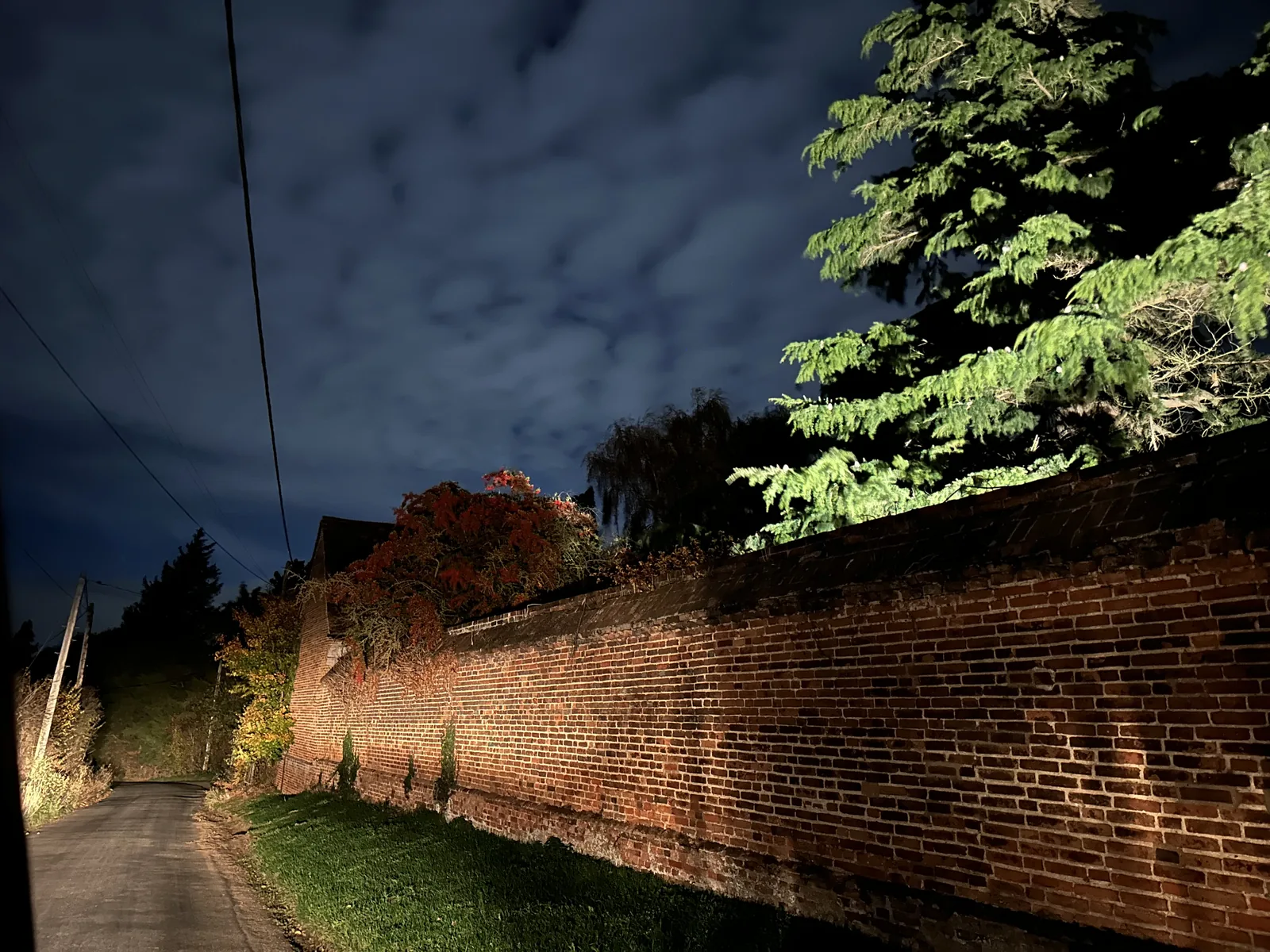 A moonlit lane beside a brick wall in Little Braxted