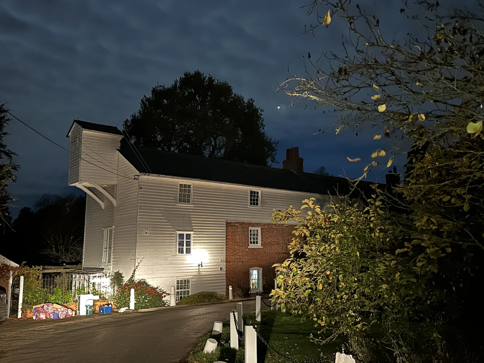 The Mill House and lane under a moonlit sky